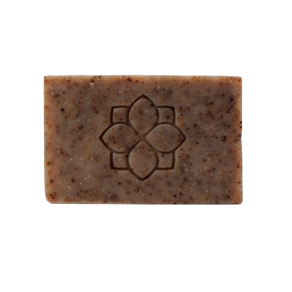 Brown bar of soap with a floral design on a white background