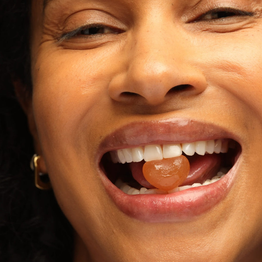 Close-up of a person with a gummy in their mouth